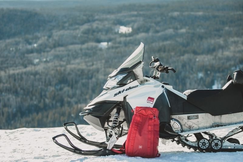 Snowmobile and backpack