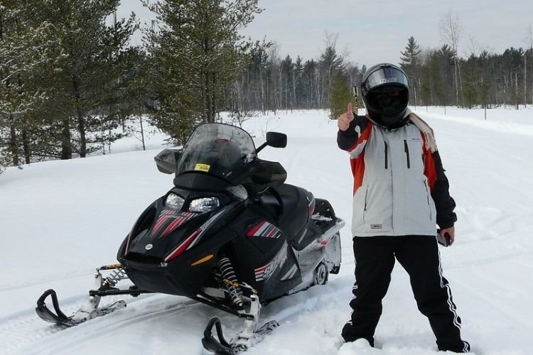 Snowmobile and me in the snow forest