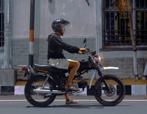 man sitting on motorcycle
