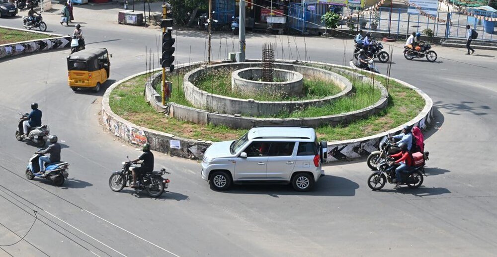some motorcycle riders are riding through a roundabout
