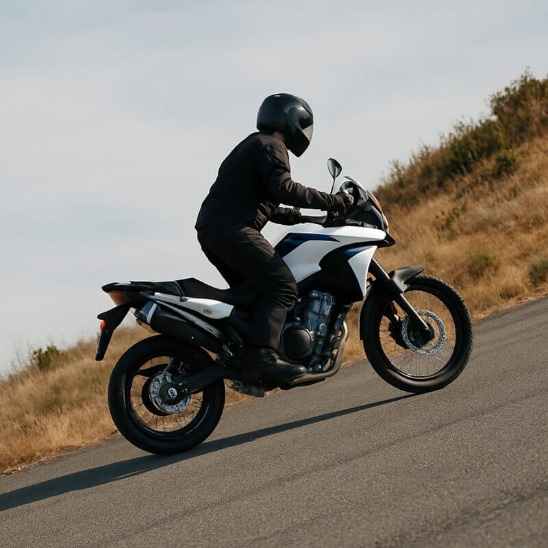 the motorcyclist is climbing the hill at low RPM