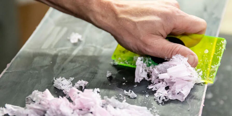 use a scraper to clear the damaged area